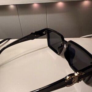 CHANEL Elegant Black Sunglasses with Gold Detail